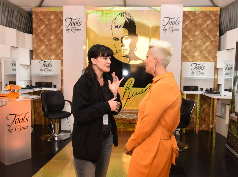 Actress Pauley Perrette chats with Tools by Gina founder Gina Rivera at the Grammy Gift Lounge.