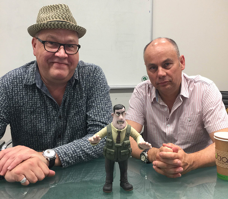 "Shaun the Sheep" co-writers/directors Richard Starzak (L) and Mark Burton show a model of a character used in the film