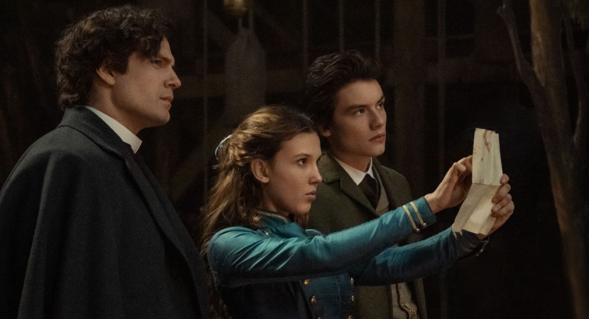 Millie Bobby Brown as Enola Holmes, Henry Cavill as Sherlock Holmes, and Louis Partridge as Viscount Tewkesbury in Netflix's 'Enola Holmes 2.'