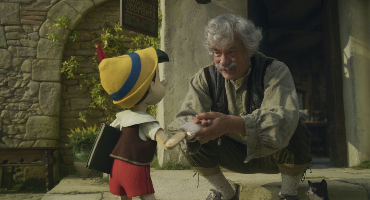 Pinocchio (voiced by Benjamin Evan Ainsworth), Tom Hanks as Geppetto, and Figaro in Disney's live-action 'Pinocchio.'