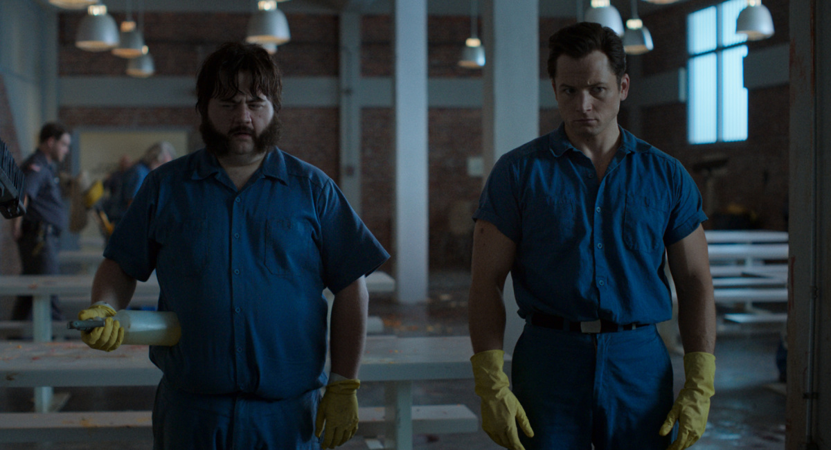 Paul Walter Hauser and Taron Egerton in 'Black Bird,' now streaming on Apple TV+.