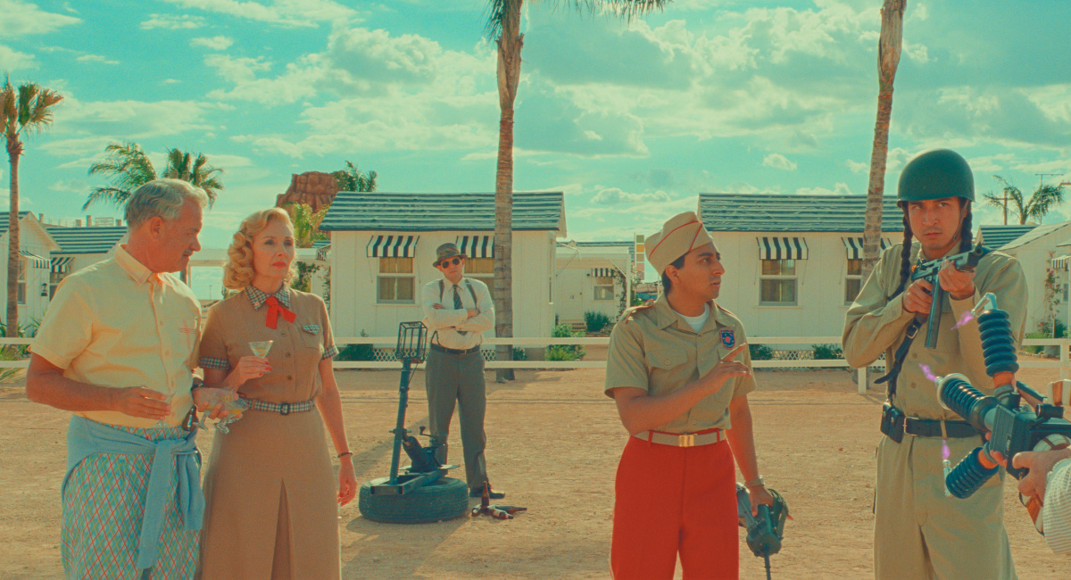 Tom Hanks as Stanley Zak, Hope Davis as Sandy Borden, and Tony Revolori as Aide-de-Camp in writer/director Wes Anderson's 'Asteroid City,' a Focus Features release.