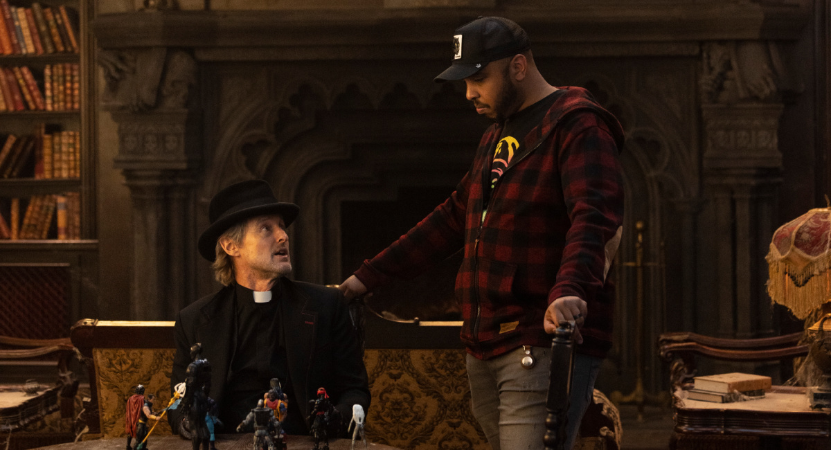 Owen Wilson as Father Kent and Director Justin Simien on the set of Disney's live-action 'Haunted Mansion.'