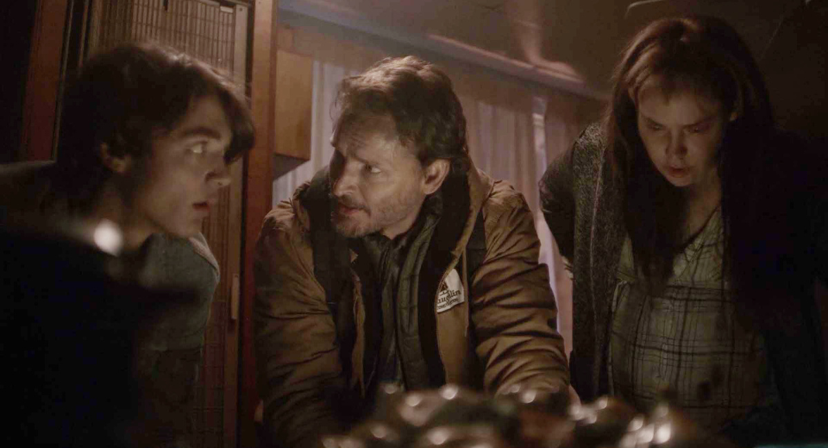 Asher Angel as “Clayton Laughlin,” Peter Facinelli as “Dave Laughlin,” and Fiona Dourif as “Sarah Laughlin” in the survival drama/thriller, 'On Fire,' a Cineverse release.