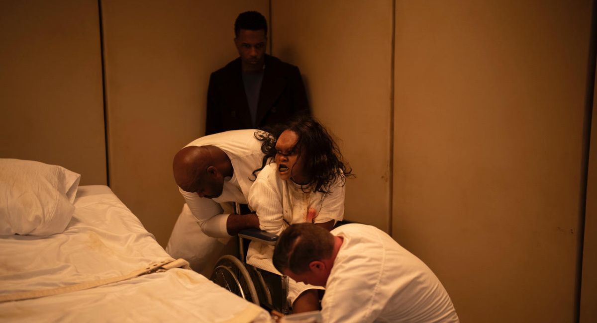 Victor Fielding (Leslie Odom, Jr., background) and Angela Fielding (Lidya Jewett) with additional cast members in 'The Exorcist: Believer,' directed by David Gordon Green.