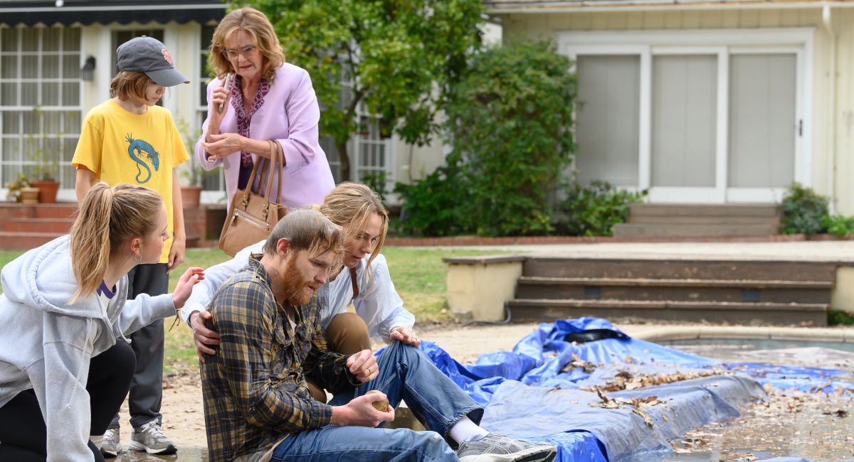 (from lower left) Izzy Waller (Amélie Hoeferle), Elliot Waller (Gavin Warren), Kay (Nancy Lenehan), Ray Waller (Wyatt Russell) and Eve Waller (Kerry Condon) in 'Night Swim,' directed by Bryce McGuire. © 2023 Universal Studios. All