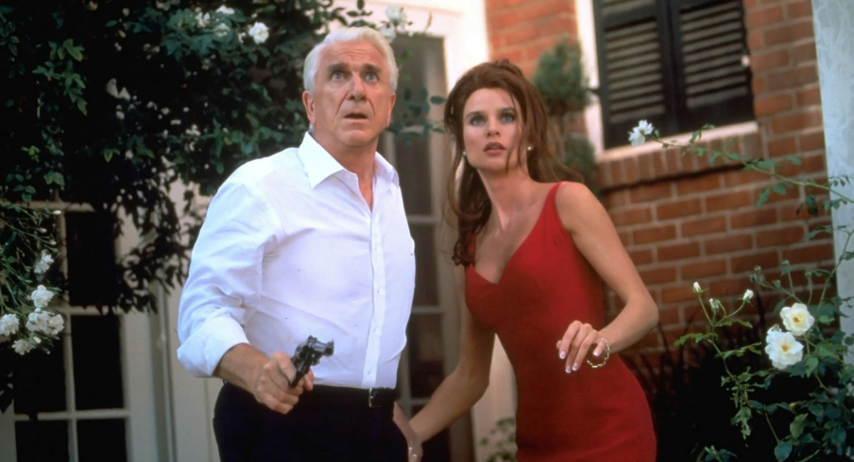Leslie Nielsen as Dick Steele and Nicollette Sheridan as Veronique Ukrinsky in 'Spy Hard.'