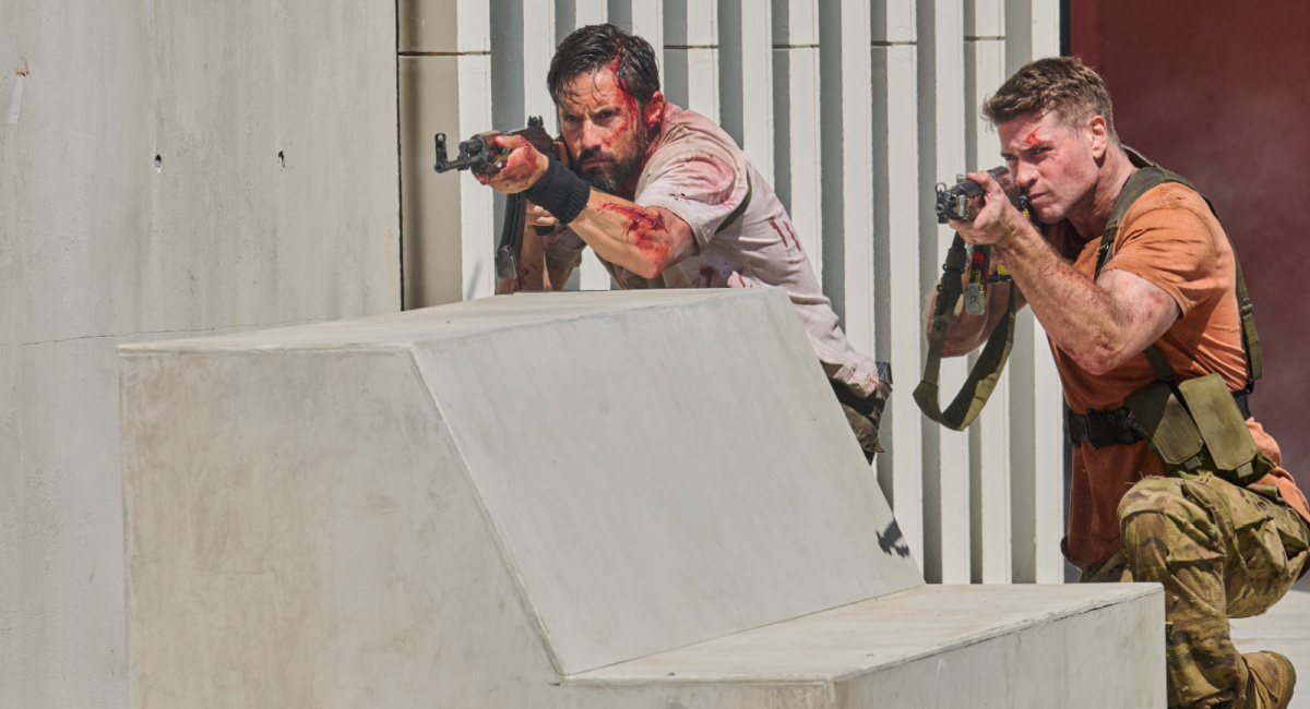 Milo Ventimiglia as Sugar and Liam Hemsworth as Kinney in the action film, 'Land of Bad,' a release by The Avenue.