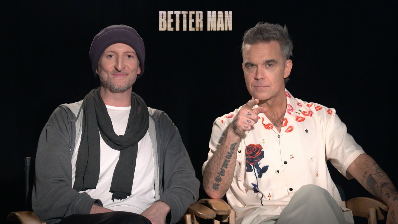 (L to R) Director Michael Gracey and Robbie Williams talk 'Better Man'.