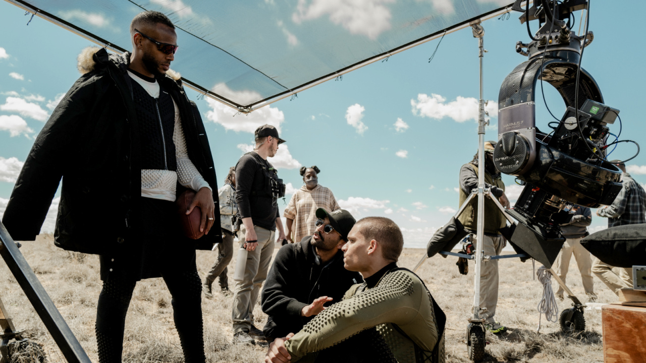 (L to R) Marlon Wayans (as Isaiah), director Justin Tipping, and Tyriq Withers (as Cam) on the set of 'HIM', from Universal Pictures.
