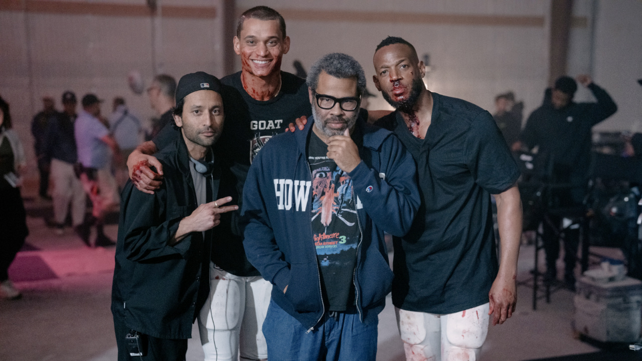 (L to R) Director Justin Tipping, Tyriq Withers (as Cam), Producer Jordan Peele, and Marlon Wayans (as Isaiah) on the set of 'HIM', from Universal Pictures.