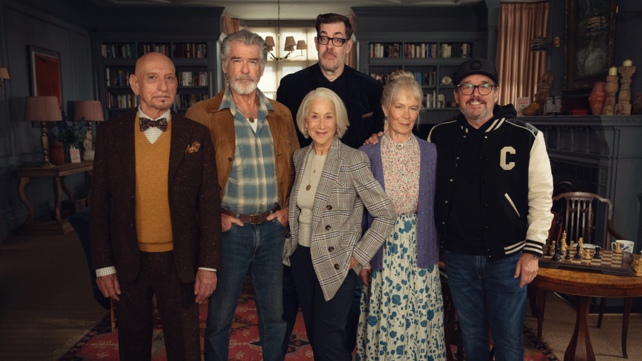 (L to R) Sir Ben Kingsley as Ibrahim Arif, Pierce Brosnan as Ron Ritchie, author Richard Osman, Helen Mirren as Elizabeth Best, Celia Imrie as Joyce Meadowcroft and director Chris Columbus on the set of 'The Thursday Murder Club'. Photo: Courtesy of Netflix © 2024. © 2025 Netflix, Inc.