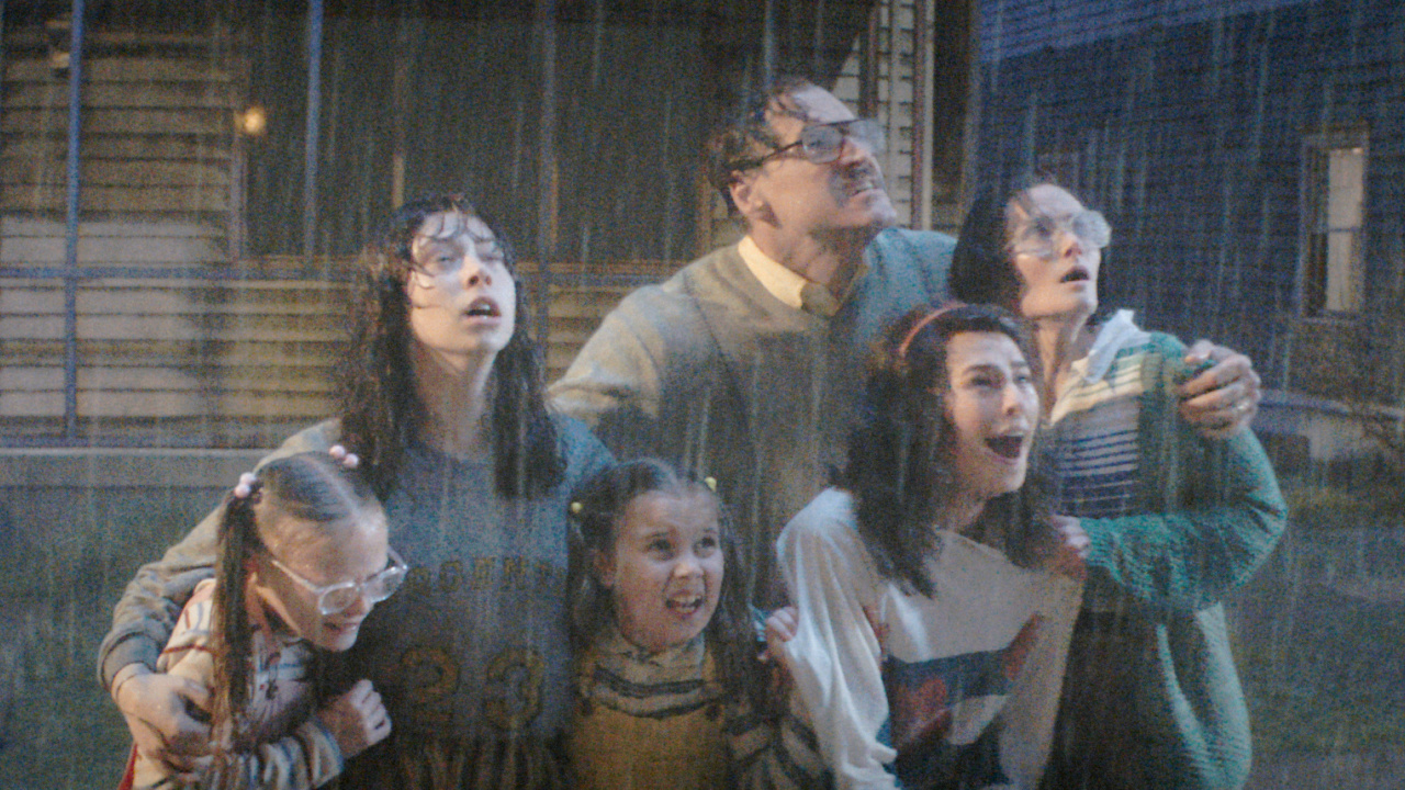 (L to R) Tilly Walker as Carin Smurl, Kila Lord Cassidy as Heather Smurl, Molly Cartwright as Shannon Smurl, Elliot Cowan as Jack Smurl, Beau Gadson as Dawn Smurl, and Rebecca Calder as Janet Smurl in New Line Cinema’s 'The Conjuring: Last Rites,' a Warner Bros. Pictures release. Photo Credit: Courtesy of Warner Bros. Pictures. Copyright: © 2025 Warner Bros. Entertainment Inc. All Rights Reserved.