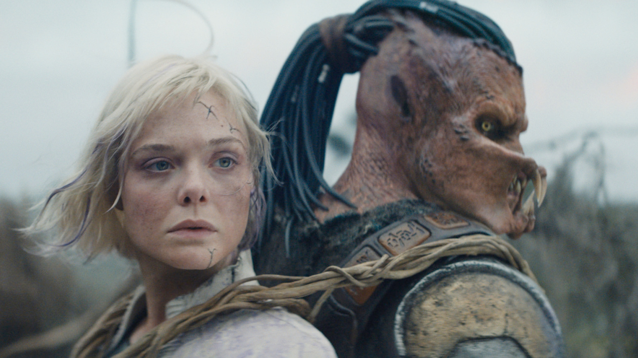 (L to R) Thia (Elle Fanning) and Dek (Dimitrius Schuster-Koloamatangi) in 20th Century Studios' 'Predator: Badlands' film. Photo courtesy of 20th Century Studios. © 2025 20th Century Studios. All Rights Reserved.