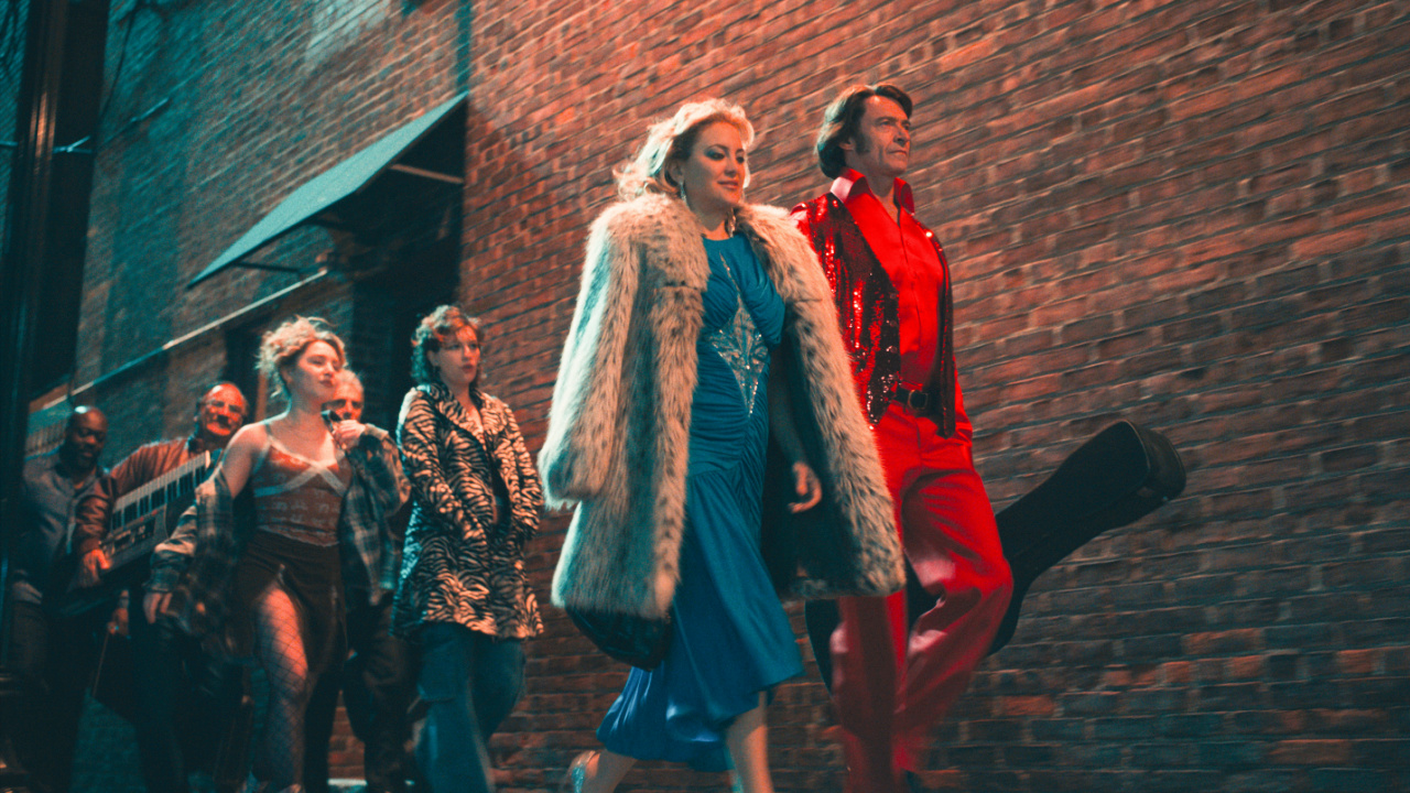 (L to R) Jim Belushi as Tom D'Amato, Ella Anderson as Rachel, Michael Imperioli as Mark Shurilla, King Princess as Angelina, Kate Hudson as Claire Stengl, and Hugh Jackman as Mike Sardina in director Craig Brewer's 'Song Sung Blue', a Focus Features release. Credit: Courtesy of Focus Features © 2025 All Rights Reserved.