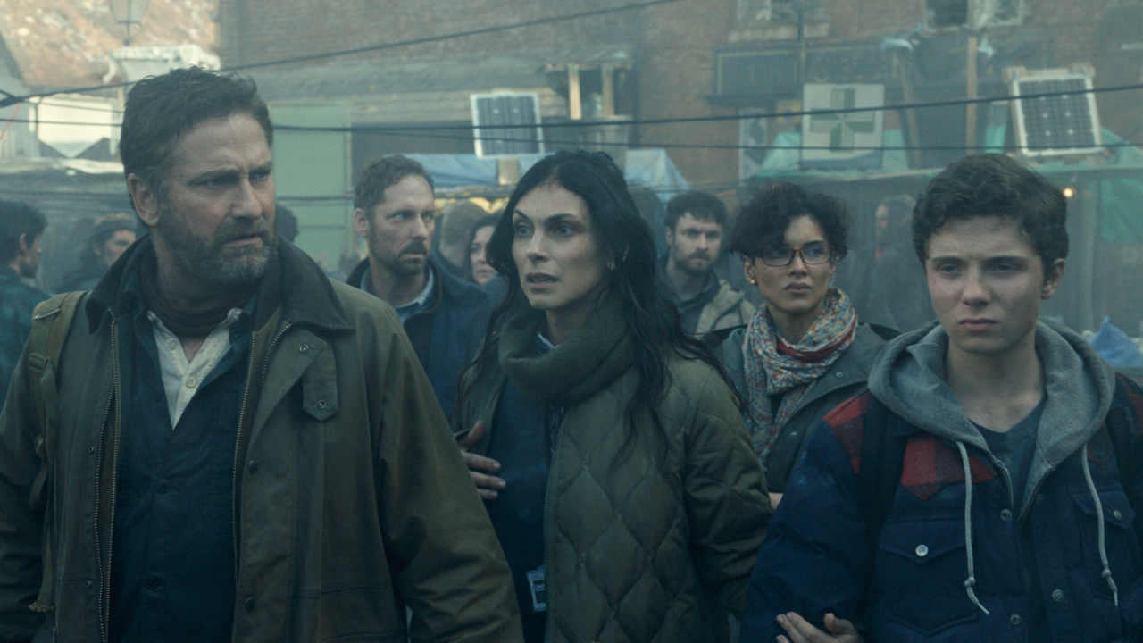(L to R) Gerard Butler as John Garrity, Morena Baccarin as Allison Garrity, Amber Rose Revah as Dr. Casey Amina, and Roman Griffin Davis as Nathan Garrity in 'Greenland 2: Migration'. Photo Credit: Courtesy of Lionsgate.