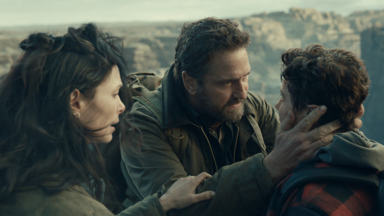 (L to R) Morena Baccarin as Allison Garrity, Gerard Butler as John Garrity and Roman Griffin Davis as Nathan Garrity in 'Greenland 2: Migration'. Photo Credit: Courtesy of Lionsgate.